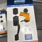 Schlage Camelot, Accent Aged Bronze Entry Handleset 1-3/4 In. Open. Price: $94.50.