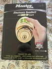 Master Lock Electronic Keyless Deadbolt With Light Up Pad Gold New. Price: $80.00.