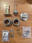 Kwikset (2-PK) Cove Satin Nickel Entry Door & Single Cylinder Deadbolt, Smartkey Open. Price: $40.00.